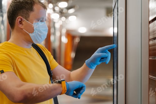 Preview: Profile shot of man checks time on watch, uses touch screen in protective rubber gloves
