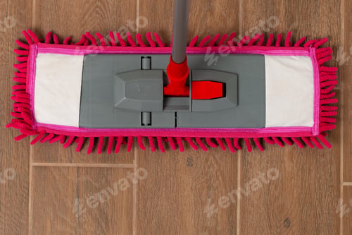 Preview: Top view of a pink mop on wooden floor