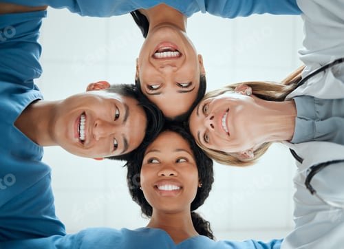 Preview: Cropped shot of a group of medical practitioners having a private huddle at work