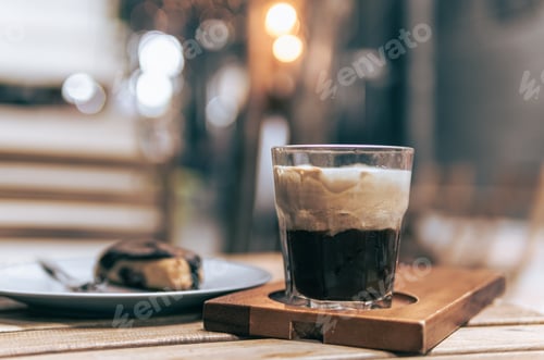 Preview: Traditional espresso coffee with white foamy cream cup on wood table, homemade cold mixed coffee