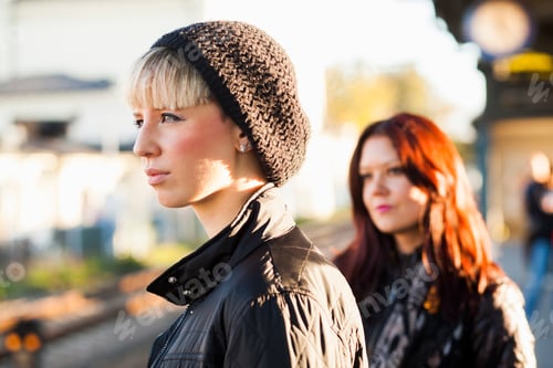 Preview: Beautiful women standing railroad station on sunny day