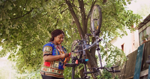 Preview: Woman examining toolkit for bike repair