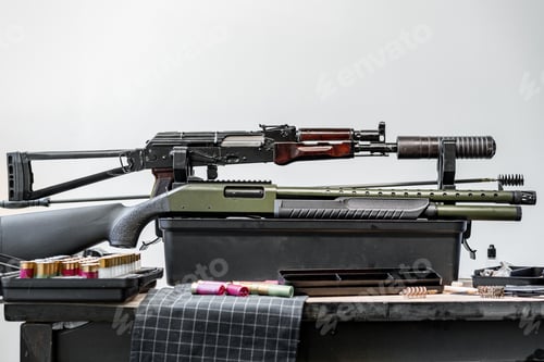Preview: Shotgun rifle with cartridges on table in a weapon workshop