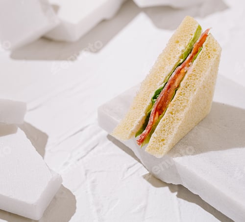 Preview: Sandwich placed on white textured surface for minimalist food styling