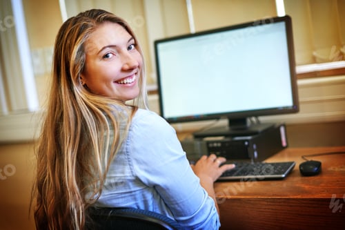 Preview: Portrait of a university student working on a computer in the library at campus