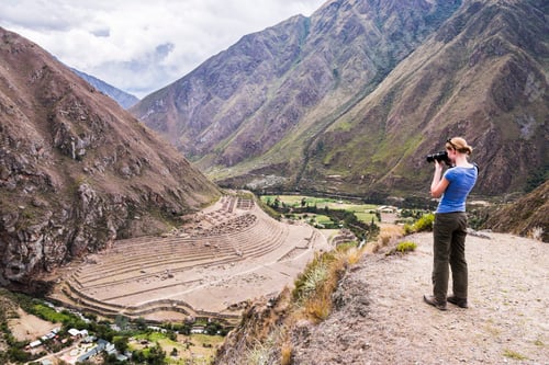 Preview: Tourist taking a photo of Llactapata Inca Ruins on Inca Trail day 1, Cusco Region, Peru, South Ameri