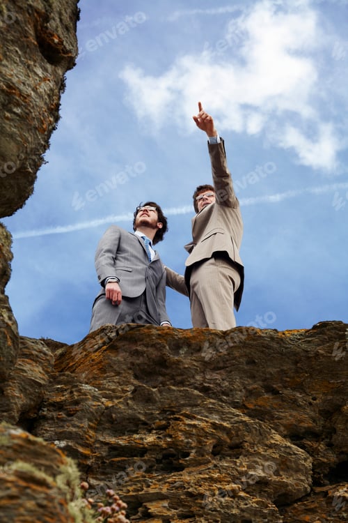 Preview: Businessmen standing on cliff edge