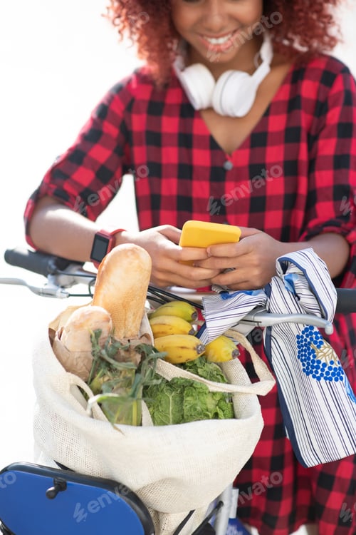 Preview: Student texting friend after buying bread and veggies