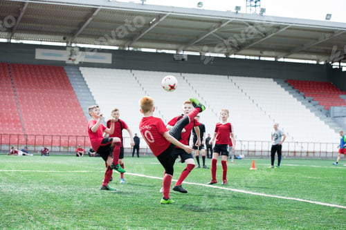 Preview: Boys Kicking Ball at Football Practice