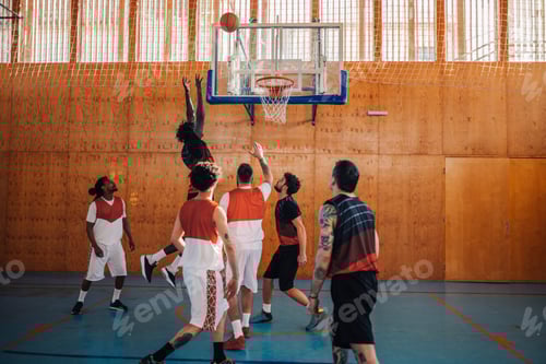 Preview: Interracial basketball players playing a game on their training.