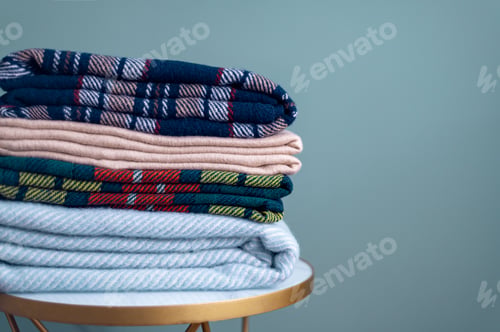 Preview: Stack of woolen checked blankets