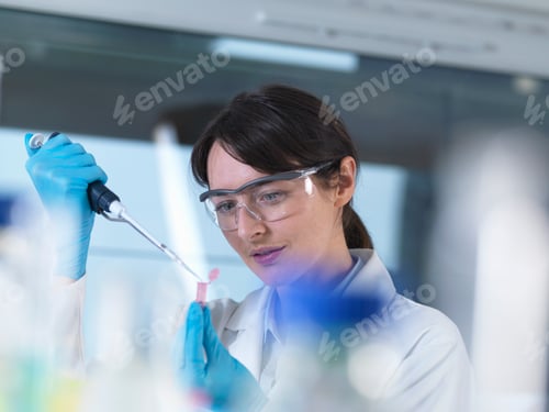 Preview: Researcher pipetting DNA sample into eppendorf vial in laboratory