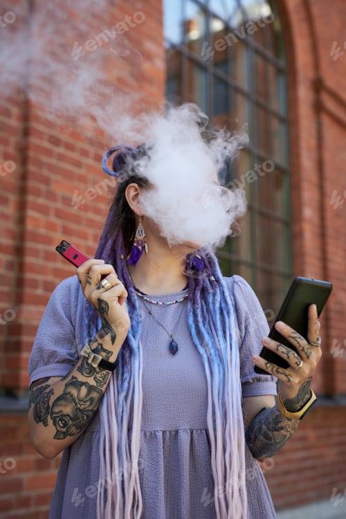 Preview: White cloud of thick cigarette smoke hiding face of young woman