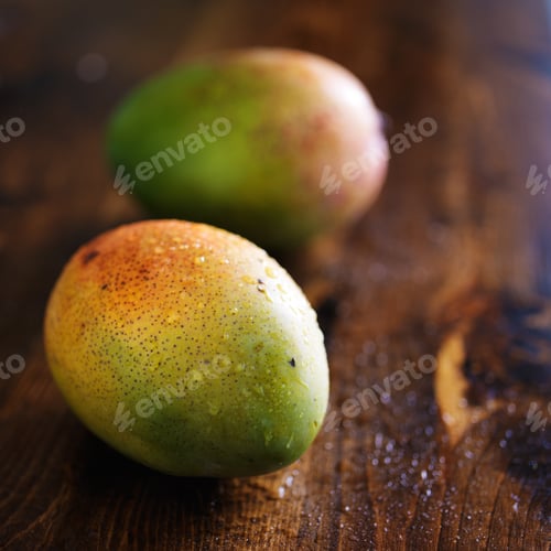 Preview: two mangos shot with selective focus
