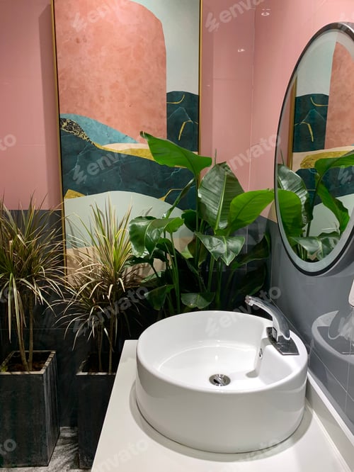 Preview: Modern bathroom interior in restaurant or cafe with green plants and pink walls