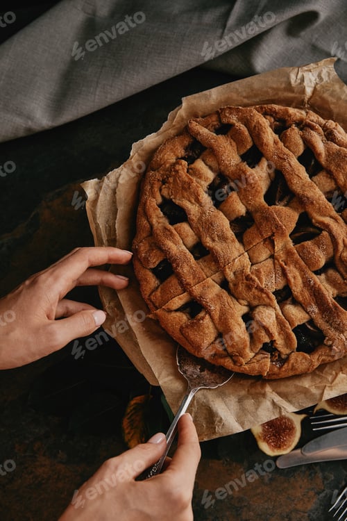Preview: partial view of woman with cake server taking piece of pie
