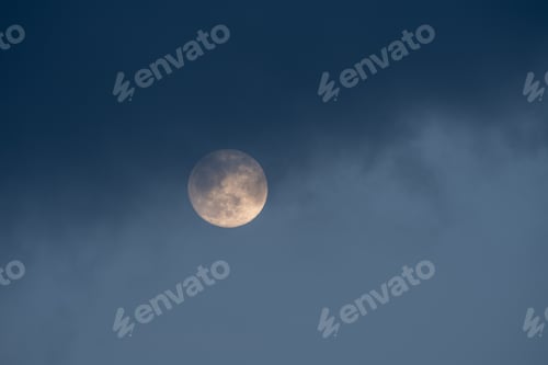 Preview: Full moon with dark clouds on a blue sky