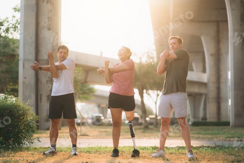 Preview: Woman exercising in a park with a friend providing support while using a prosthetic leg.
