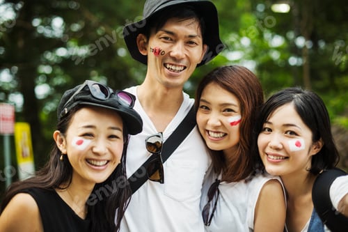 Preview: Four young people outdoors, faces painted with Japanese flags