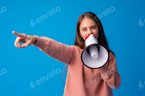 Preview: Teen girl making announcement with megaphone at blue studio