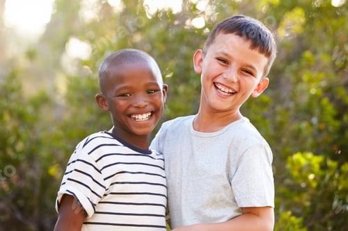 Preview: Portrait of two boys outdoors laughing and looking to camera