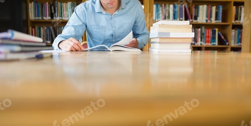 Preview: Mid Section Of A Mature Male Student Studying At Desk In The Library