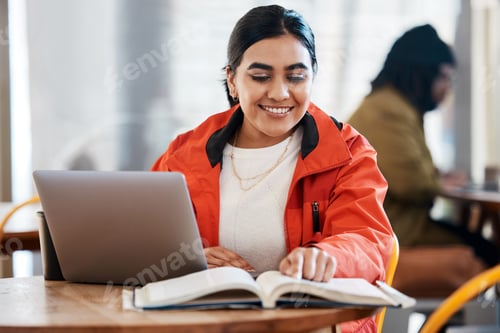 Preview: Smiling Woman Studying with Laptop and Textbook