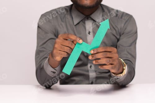 Preview: business man holding a graph line pointing up