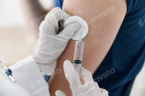 Preview: doctor gives an injection in the shoulder Patient covid vaccination