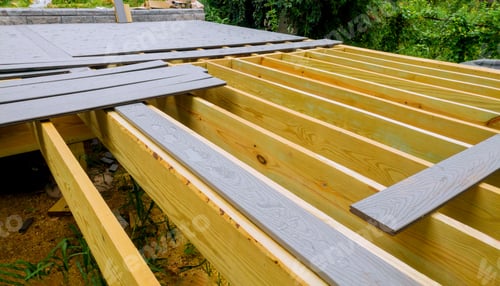 Preview: A new wooden, timber deck being constructed. it is on the decking. New deck patio