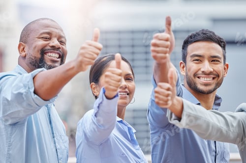 Preview: Shot of a group of businesspeople showing a thumbs up against a city background