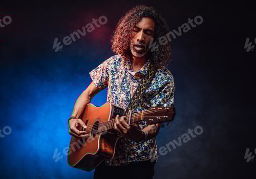 Preview: Man with Curly Hair Playing Acoustic Guitar