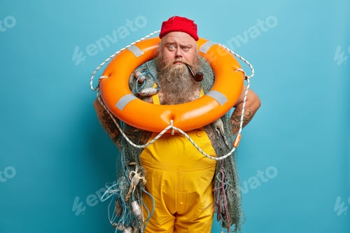 Preview: Experienced sailor carries inflated swim ring and smoking pipe, busy with vessel mainetnance, enjoys