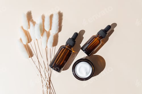 Preview: Set of Eco cosmetics products. Face serum dropper bottle and cream jar in glass packaging. Zero wast