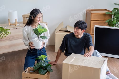 Preview: Happy Couple Unpacking Boxes and Moving into New Home, Starting Fresh in Modern Living Space