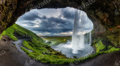 Preview: Natural cave with Seljalandsfoss waterfall flowing in summer at Iceland