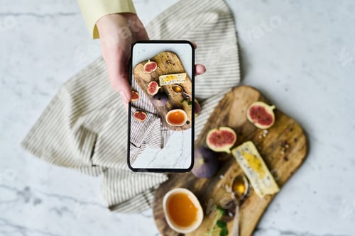 Preview: Photographer taking photo on smartphone
