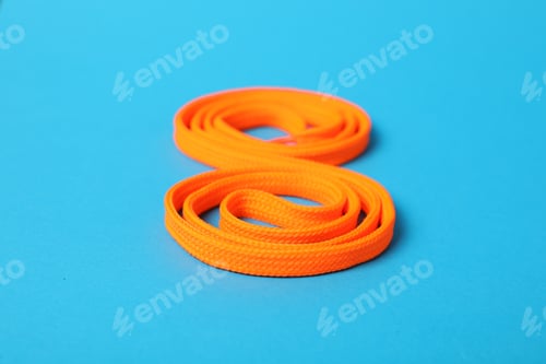 Preview: Orange shoe lace on light blue background