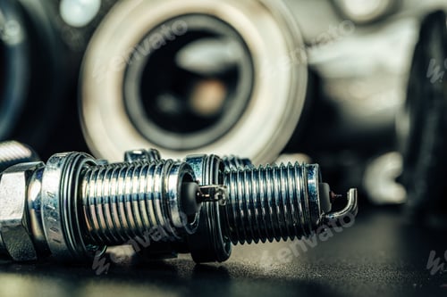 Preview: Car spark plugs on black background close up