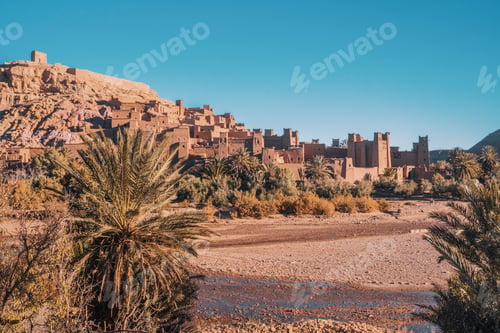 Preview: Ancient stone buildings near palms and water