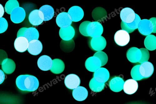 Preview: Unfocused abstract colourful bokeh black background. defocused and blurred many round blue light