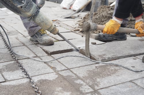 Preview: Construction workers are using power tools on the concrete pavement in the city