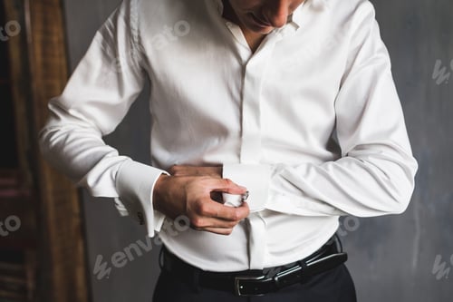 Preview: Man Fastening Cufflinks on White Shirt Sleeve