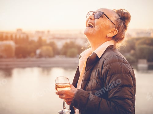 Preview: Senior woman with glass of wine