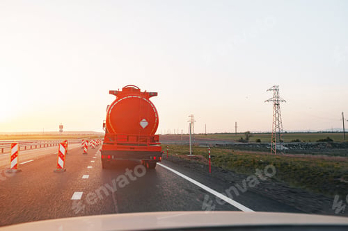 Preview: Truck driving on highway road at sunrise
