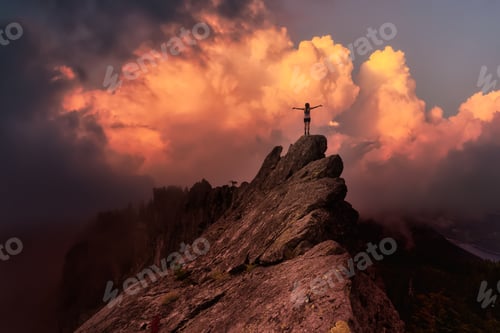 Preview: Adventurous Girl on top of a rugged rocky mountain