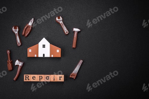 Preview: Repair or home improvement tools and a house model on a plain background