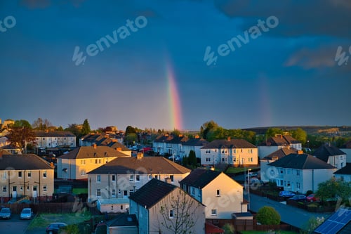 Preview: Rainbow spanning the sky over a bustling urban landscape.