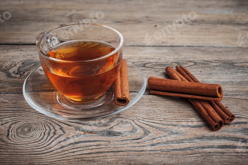 Preview: aromatic hot cinnamon tea on wooden table