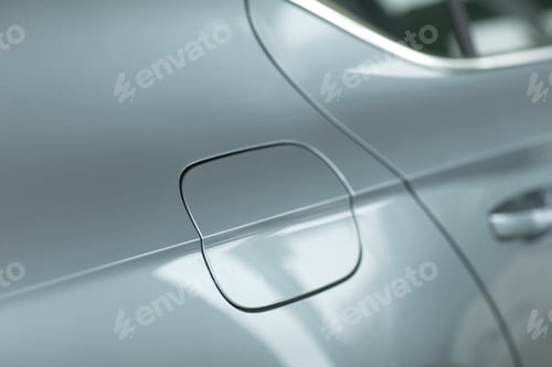 Preview: Close up of a closed petrol cap cover on a modern grey car. Oil tank cover for customers. Using